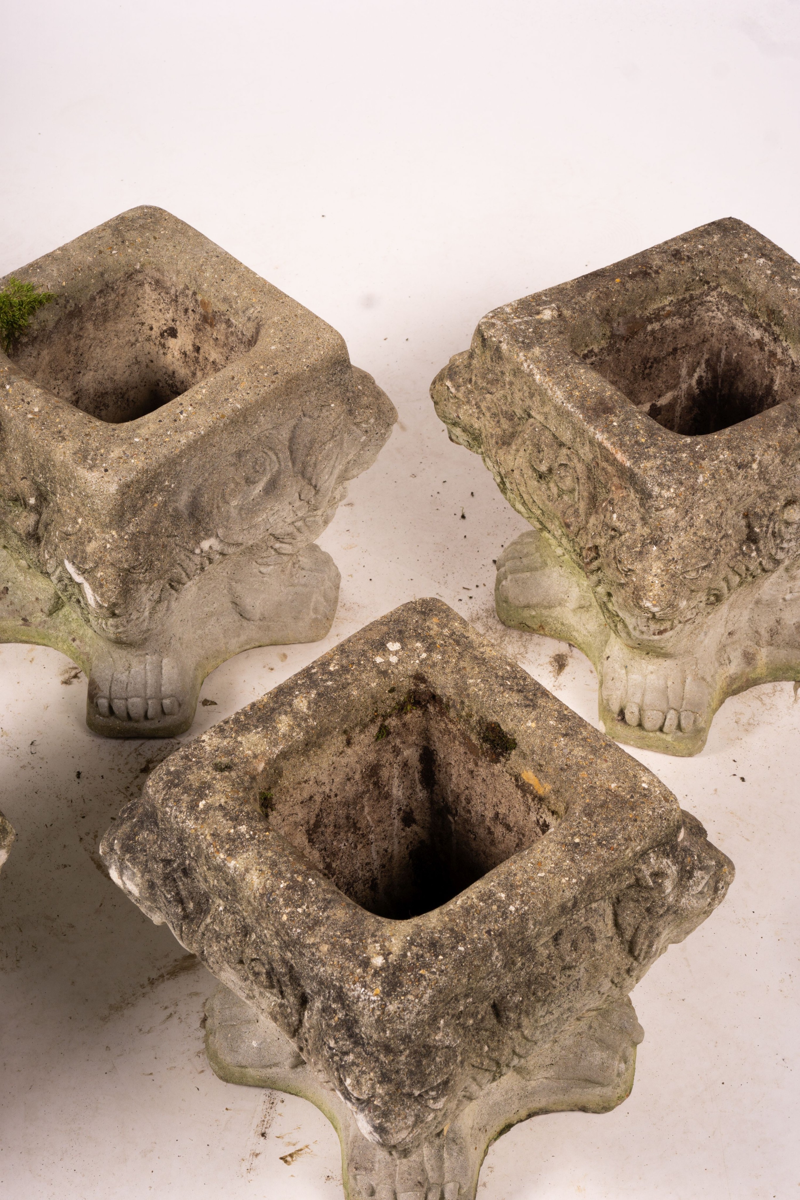 A set of five reconstituted stone lion mask square garden planters, W.30cm H.32cm